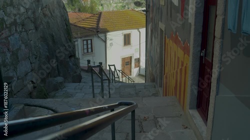 Old narrow street with stairs in a traditional Porto neighborhood.