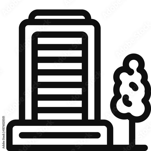 A modern office building with a tree in the foreground viewed from the side