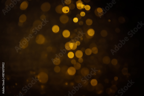Blurred photo with golden dots visible glittering, shining brightly look and feel luxurious Suitable for use as a wallpaper