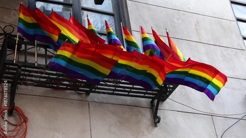 rainbow flags waving in window (symbol gay pride month celebration) west village manhattan new york city trans queer lesbian solidarity lifestyle alternative lifestyles advocacy struggle equality lgbt