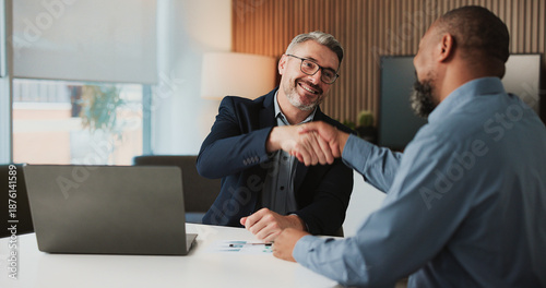Tableau sur toile Shaking hands, agreement and business men in office for finance partnership, deal or collaboration