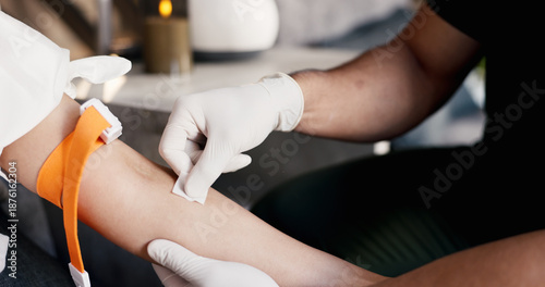 Fotografie Doctor, hands and patient with arm strap for IV drip, medical injection or needle prep in clinic