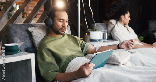 Canvastavla Headphones, man and tablet with drip therapy in lounge for nutrients, recovery or streaming app
