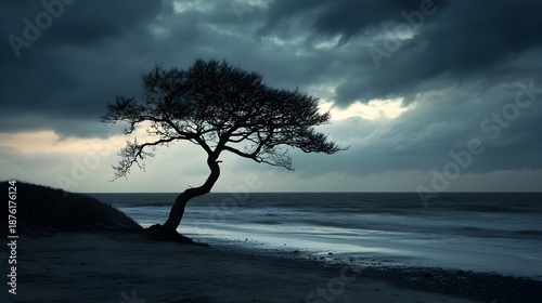 Solitary windswept tree silhouetted dramatically against a turbulent ocean horizon under an ominous, dark stormy sky at twilight