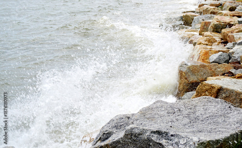 Waves crash against the rocks on the beach, Close up shot