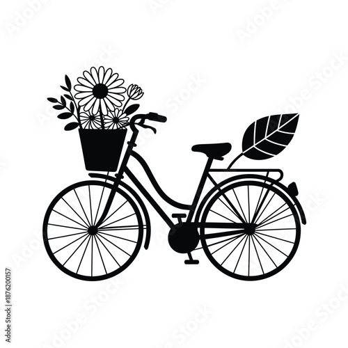 a black bicycle with flowers in the basket and a leaf on the back