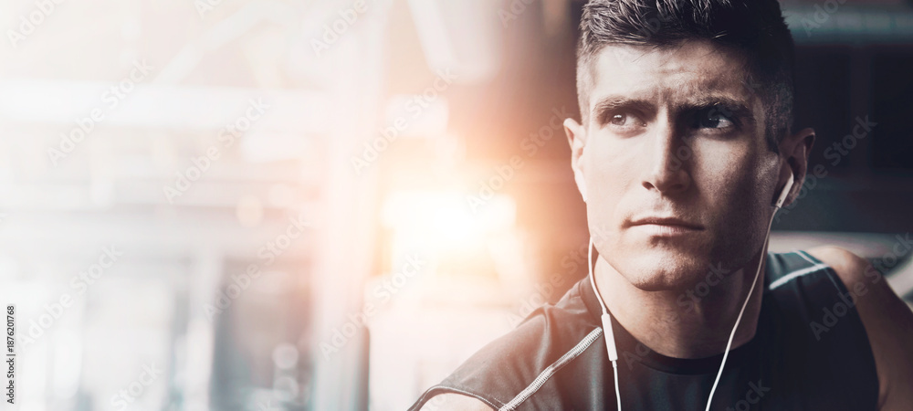 Naklejka premium Thinking, fitness and earphones with man in gym for workout reflection, streaming radio and health. Wellness podcast, exercise and music with person in sports club for vision, memory and space