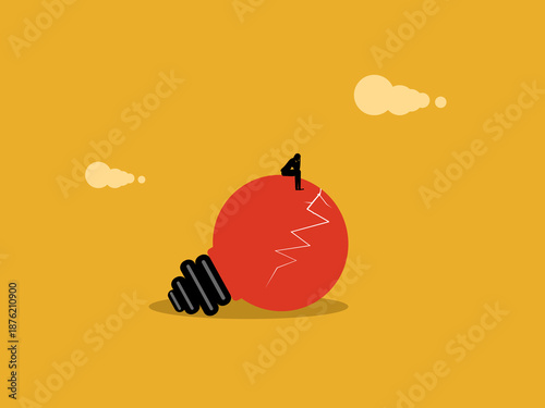 businessperson sits dejected on a broken light bulb.