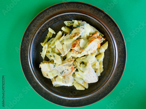 Creamy chicken and spinach pasta with thinly sliced Parmesan cheese. 