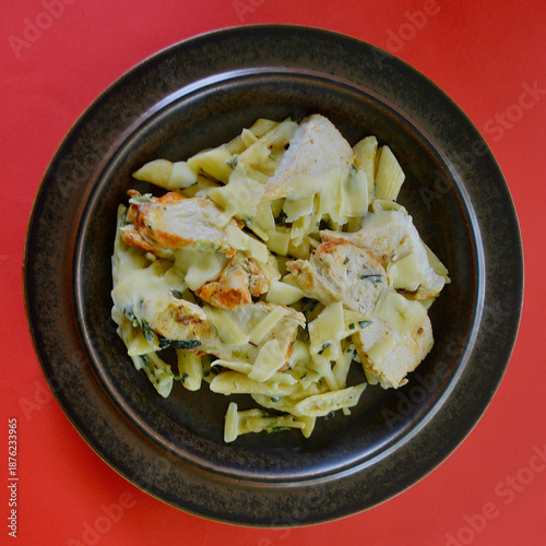 Creamy chicken and spinach pasta with thinly sliced Parmesan cheese. 