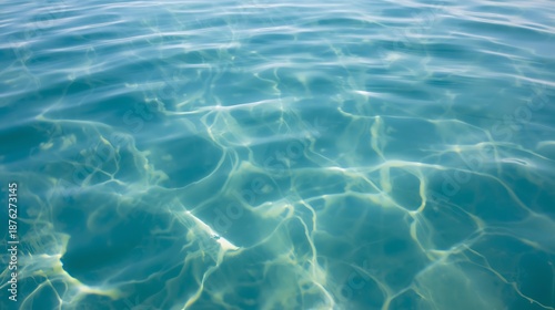 Calming ocean water surface with sunlight reflections