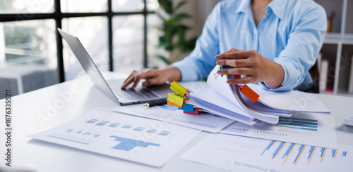Quadro su tela Businesswoman hands working in Stacks of paper files for searching and checking