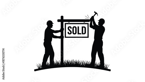 Two workers installing sold sign on lawn with hammer and post real estate concept