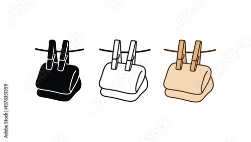 Three clothespins holding towels in different colors on a line
