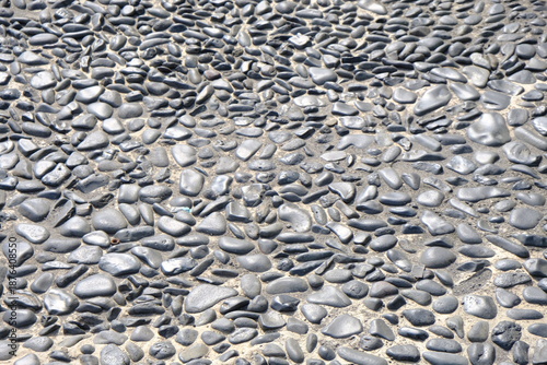 Resort flooring made of black natural pebble stone; tropical style.