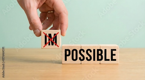 Plakat impossible to possible, hand changing blocks