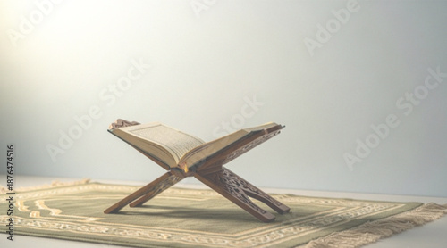 Fotografie al quran Open book on wooden stand resting on a prayer mat