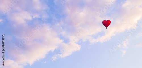 Romantic travel background with a red heart shaped balloon flying in the vast pastel sky, suitable for St Valentines day, concept of air travel and adventure, pastel tones applied