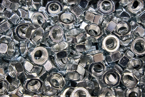 Fotografia Lots of Hex Nuts fasteners selective focus background