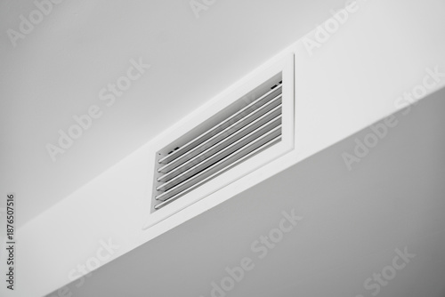 White ceiling air vent grille in modern home interior, clean HVAC ventilation system detail with minimal architectural lines