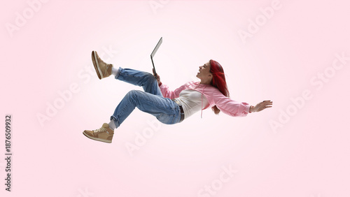 Фотография Young freelancer working remotely with laptop in mid air