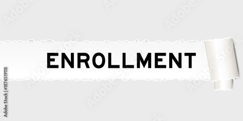 Ripped gray paper background that have word enrollment under torn part