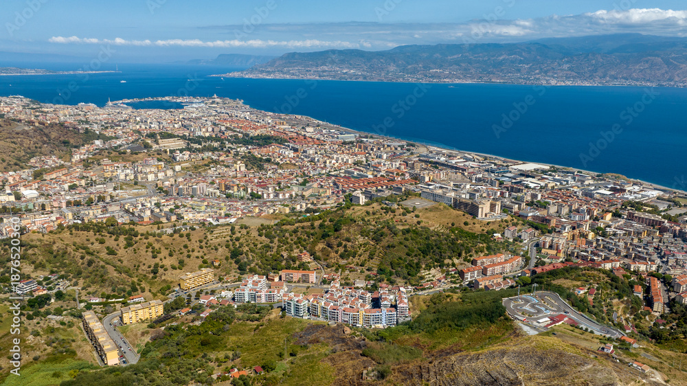 Fototapeta premium Aerial view of the Strait of Messina. It is a narrow strait between the eastern tip of Sicily and the western tip of Calabria, in Southern Italy. It connects the Tyrrhenian Sea with the Ionian Sea.