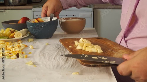 A man prepares fruit ice cream for dessert.
