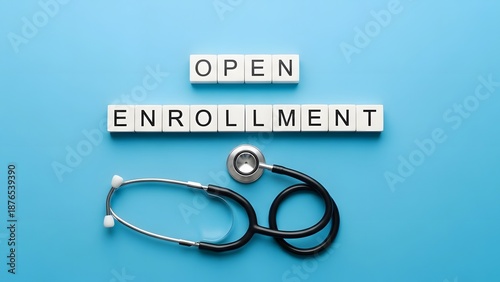 Medical health insurance open enrollment period. Healthcare benefits and medical coverage. Stethoscope lying on a blue background next to letter tiles spelling open enrollment
