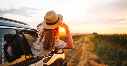 Εκτύπωση καμβά Young happy woman leaning out of the car window enjoying travel