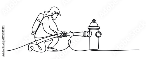 Professional firefighter in protective gear connecting a fire hose to a hydrant during an emergency operation for safety and rescue services promotion