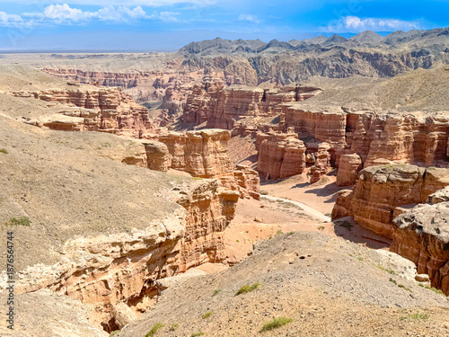 Stunning Aerial View of Desert Canyon Landscape Under Bright Blue Sky Bishkek, Kyrgyzstan