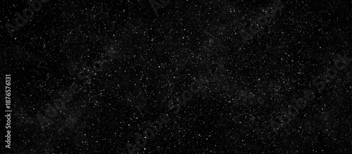 winter snowfall on a black background. starry night pattern with sparkling effect.