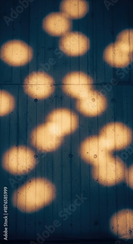 Abstract circular light patterns casting shadows on a textured concrete wall surface
