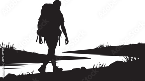 Silhouette of a Hiker with Backpack Walking Near a River