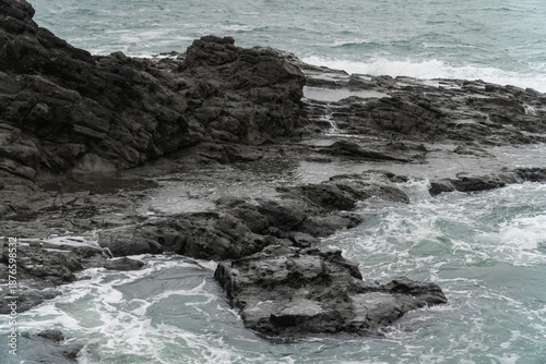 Massive coral rocks were washed by sea waves in the coastal area of Wediombo Beach. A travel destination in Yogyakarta, Java, Indonesia, Asia.