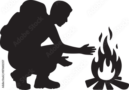 Silhouette of person warming hands over a campfire