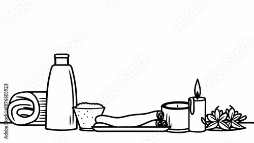 Spa essentials arranged on a serene surface with a lit candle and leaves