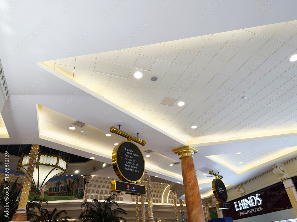 Naklejka premium Bright interior of a stylish Manchester shopping mall with elegant ceiling lighting and signage in Manchester UK
