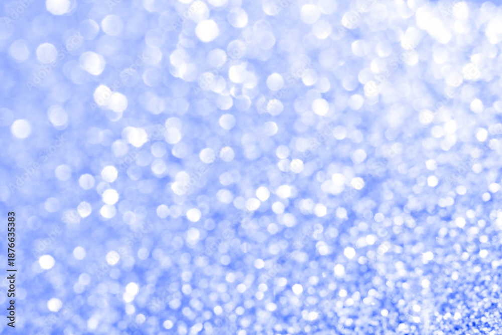 Fototapeta premium Abstract blue bokeh background with soft light dots creating a dreamy sparkling effect.