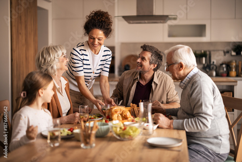 Happy multi-generational family enjoying festive lunch together
