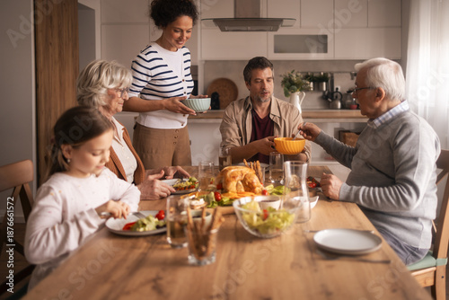 Cuadro en lienzo Multi-generational diverse family enjoying lunch together at home