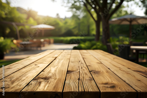 Rustic Wooden Table in Garden with Blurred Green Background.