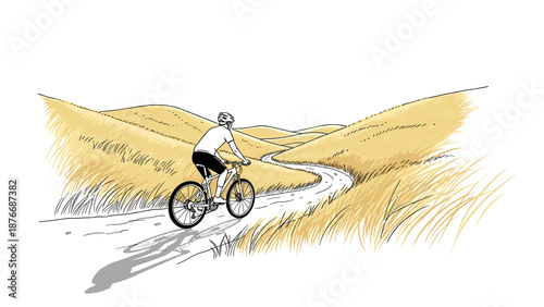 Cyclist on serene rural path through golden hills