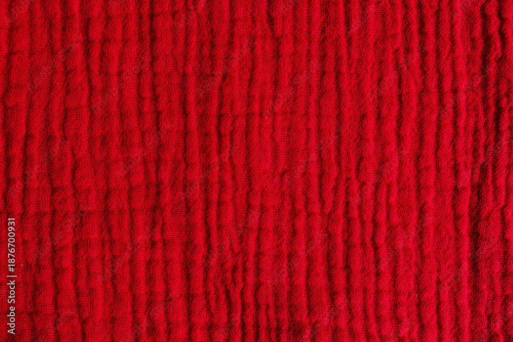 Fototapeta premium Lightweight red muslin cloth with wrinkled texture, fabric surface
