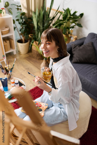 Photography Young creative woman finds joy in painting and sipping a drink at home in a cozy