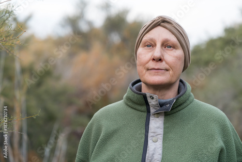 Konstfotografi Mature woman cancer survivor wearing head scarf outdoors