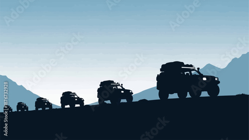 Off road vehicles driving on a mountain road at sunset.