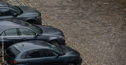 Parked cars on a cablestone pavement on a street in old town Sofia, Bulgaria. Copy space.