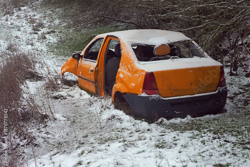 Abandoned yellow car in winter